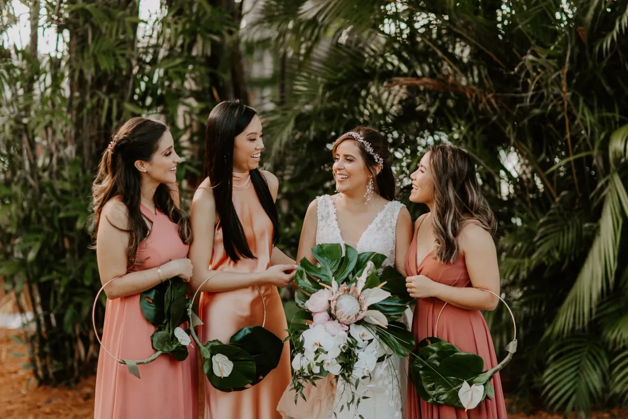 Bride with bridesmaids in tropical garden
